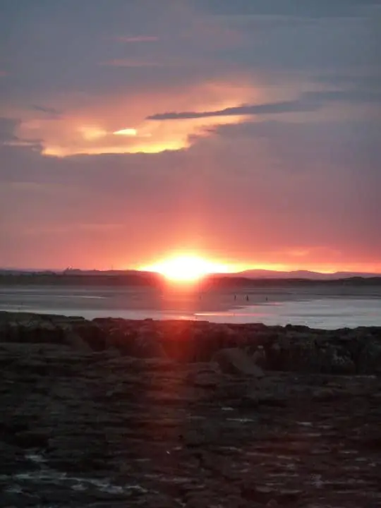 The sun setting over a calm sea, representing hypnotherapy relaxation on Tyneside